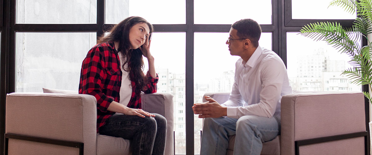 Person wondering when to seek therapy speaking with a counselor