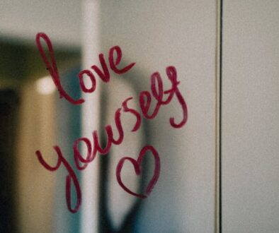 Woman practicing self-esteem counseling and self-compassion with love yourself message