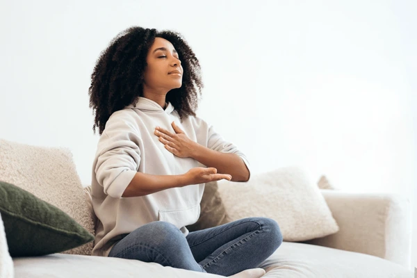serene-young-woman-practicing-breathing-600nw-2614292425
